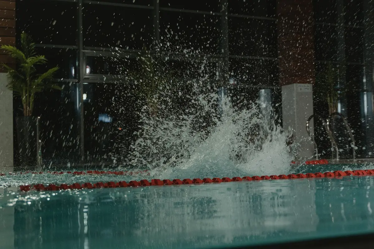 Water splashing up out of an indoor swimming pool