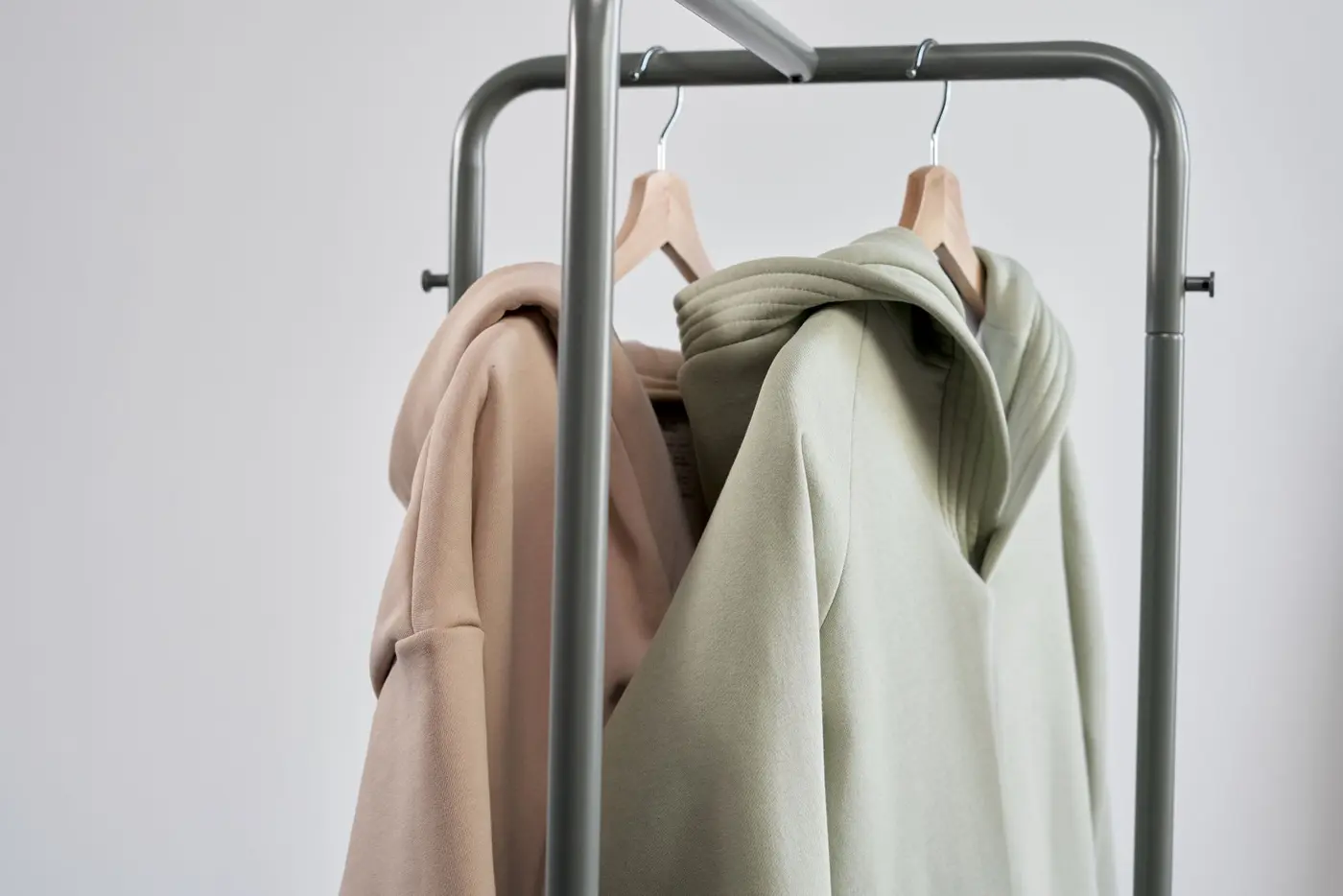 Custom hoodies hanging on a clothing rack