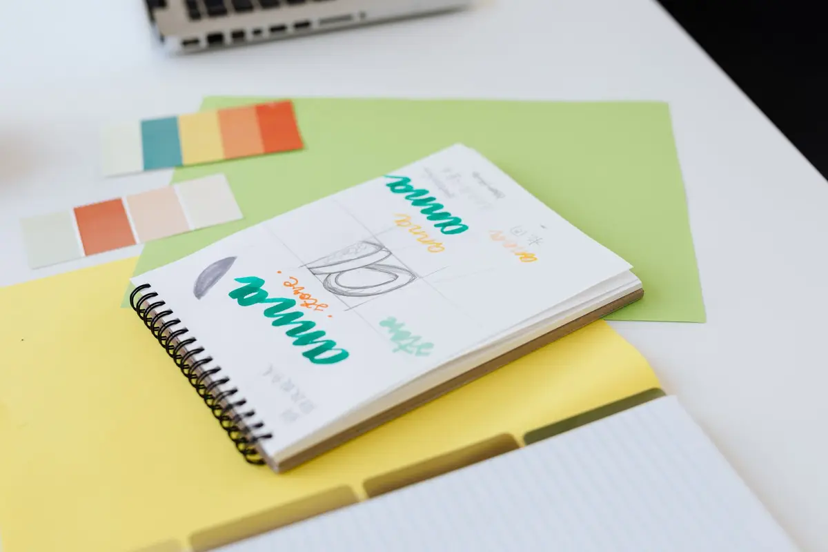 Brand color swatches and design sketches laid out on a desk