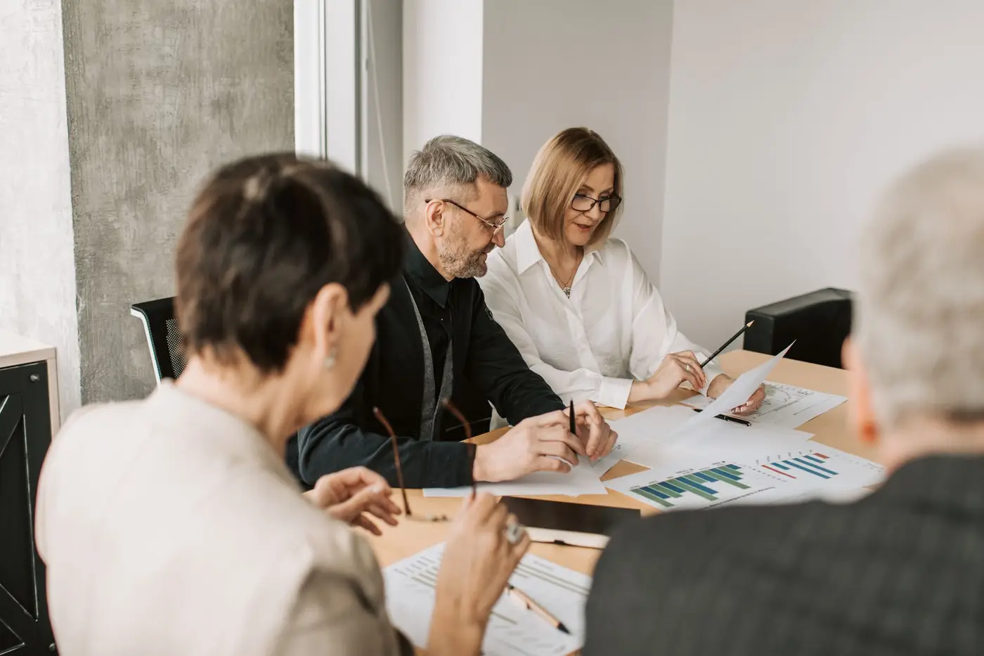 A team reviewing documents together at a table