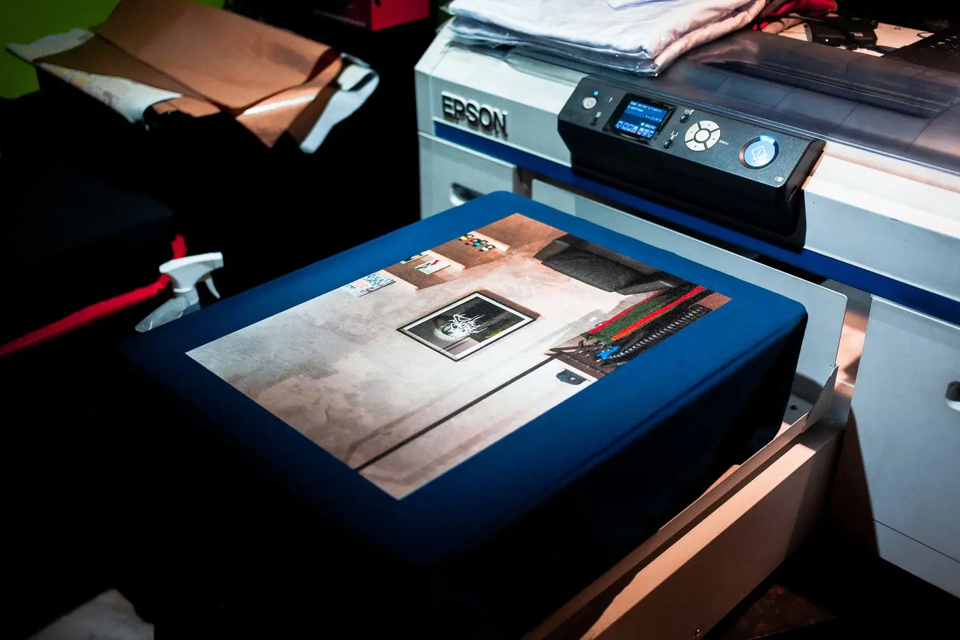 A digital printer applying a full-color custom design onto fabric
