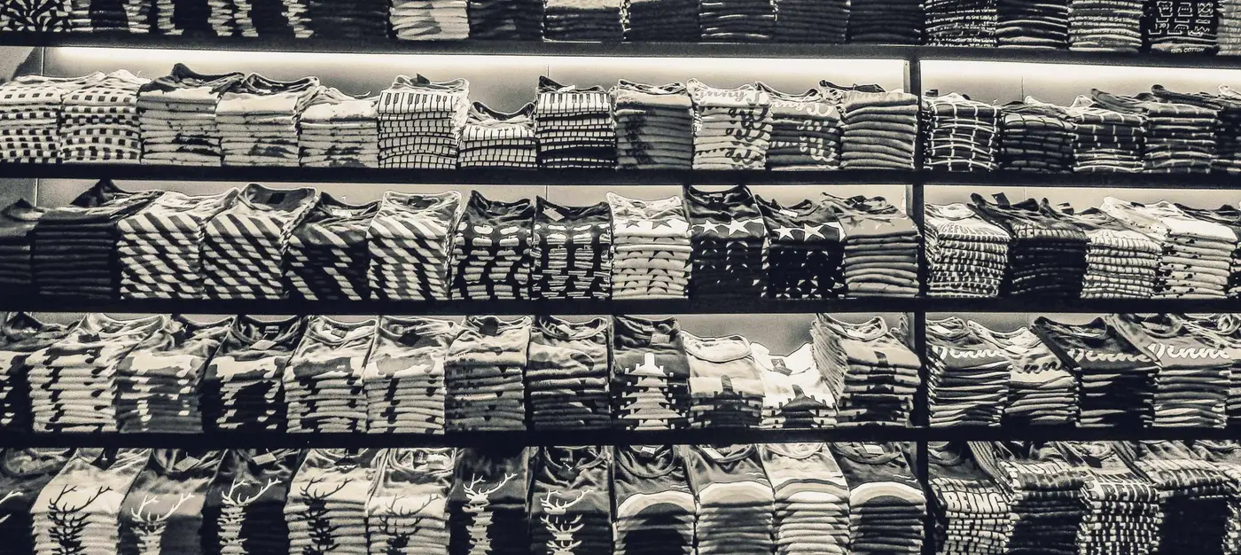 Neatly folded branded apparel stacked on shelves
