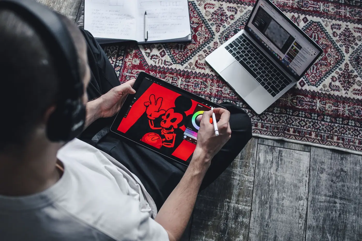A person sketching a t-shirt graphic on a drawing tablet