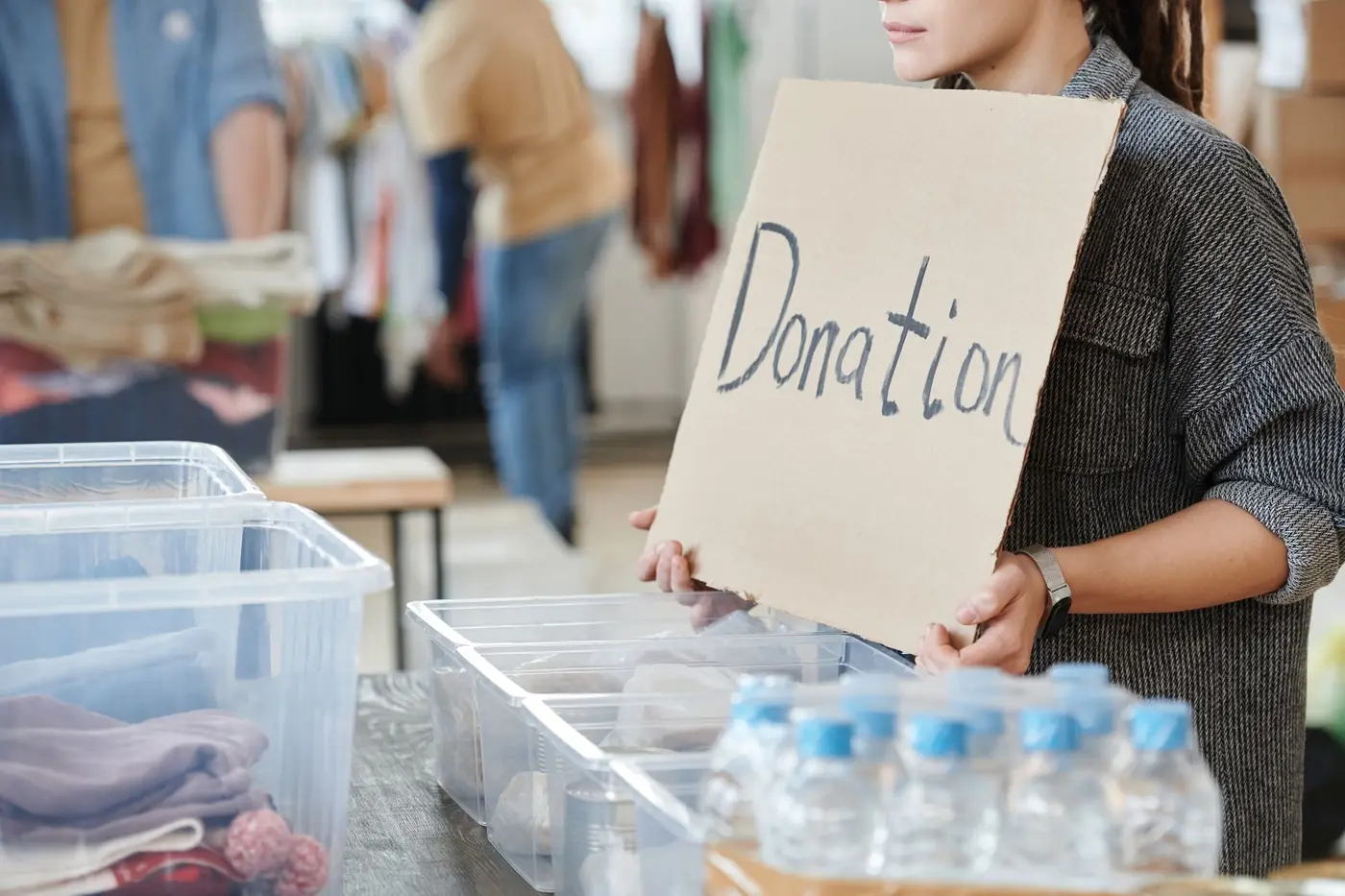A volunteer holding a donation sign at a community charity event