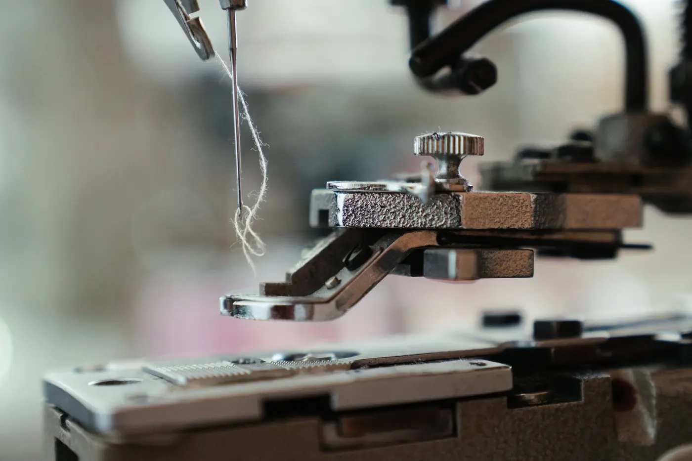 Close-up of an embroidery machine needle and thread