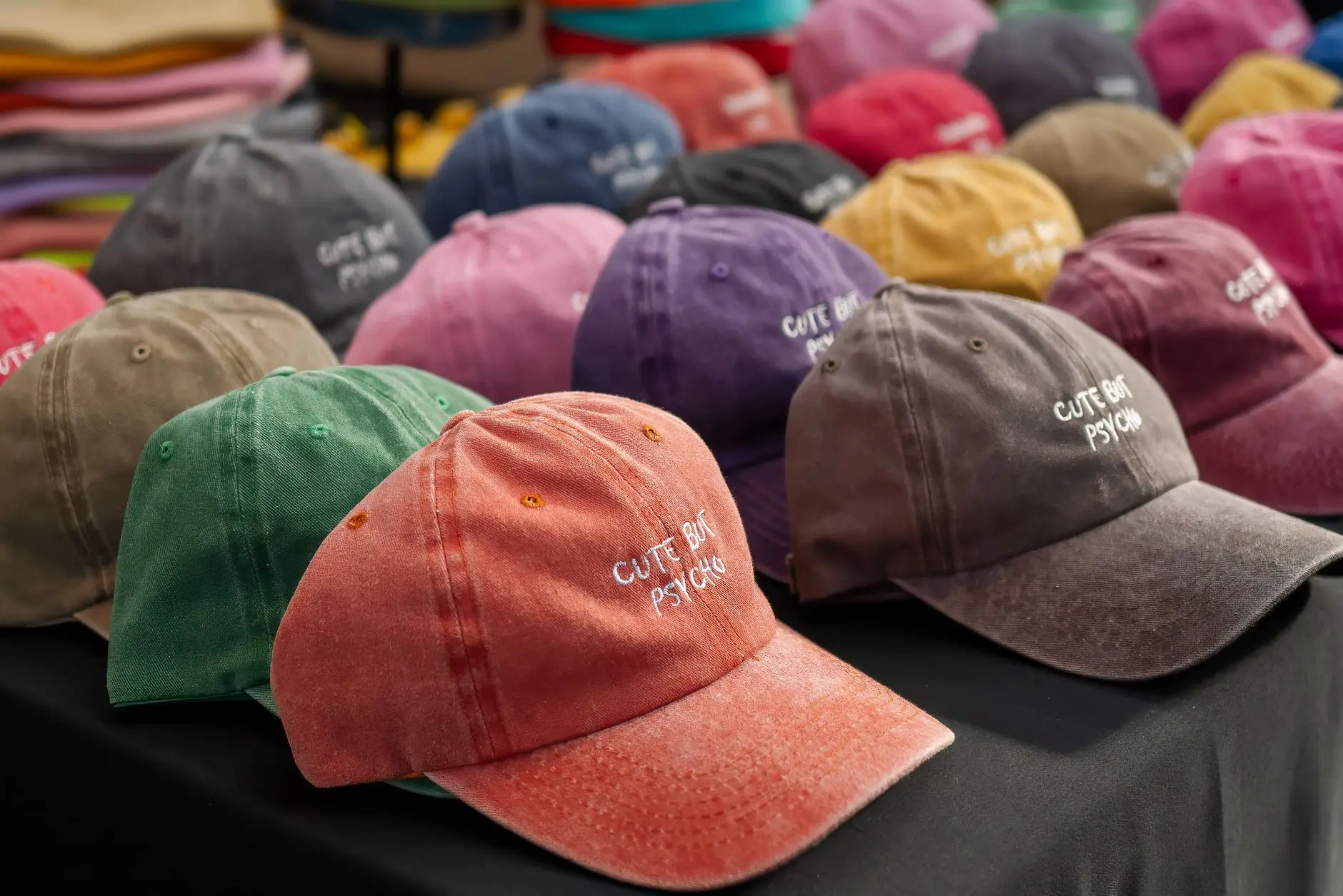 Embroidered caps displayed on a table