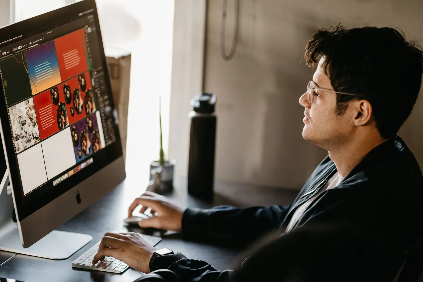A designer refining a company logo on a computer before it goes to embroidery