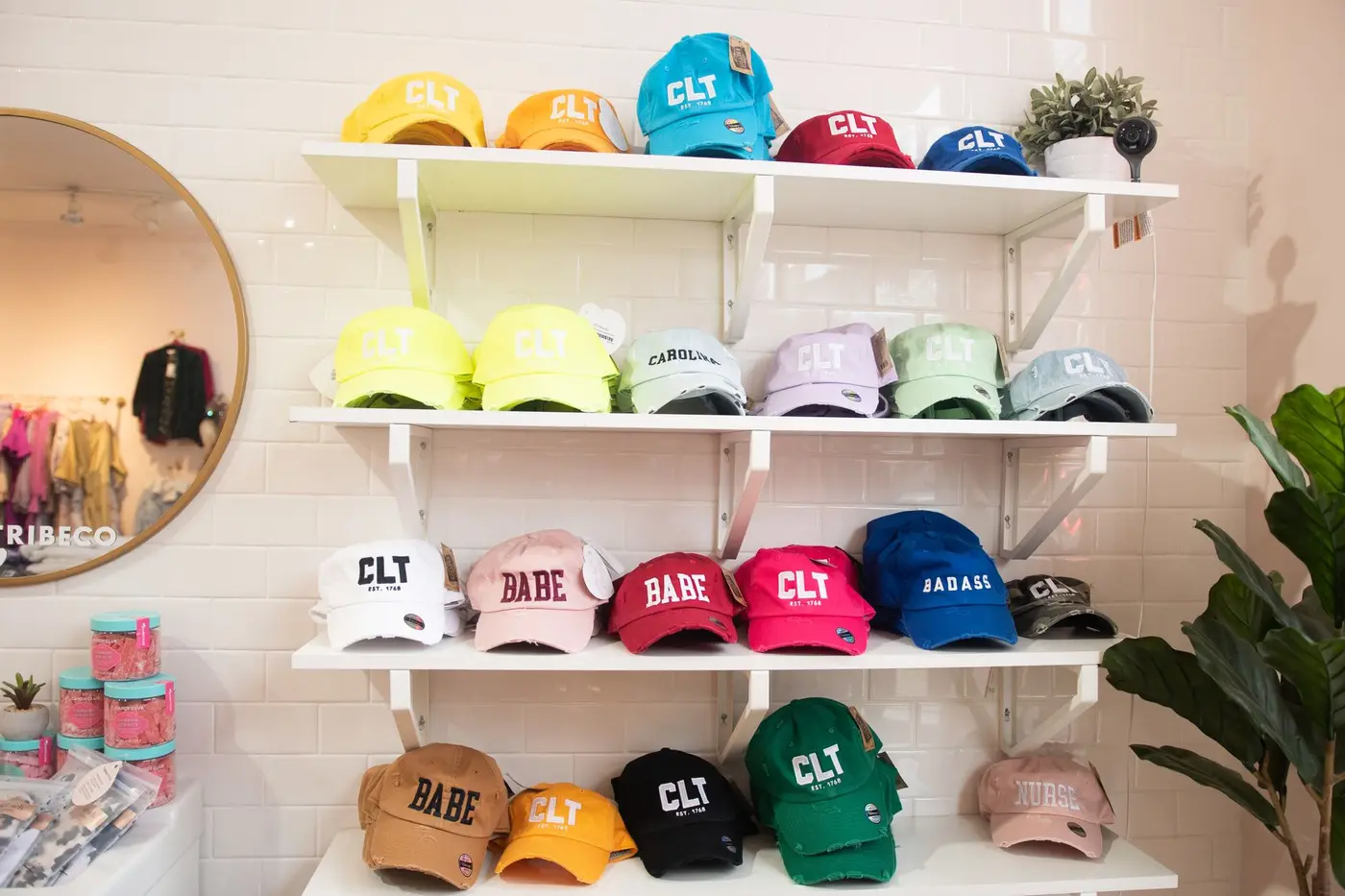 A display wall of baseball caps in a range of colors