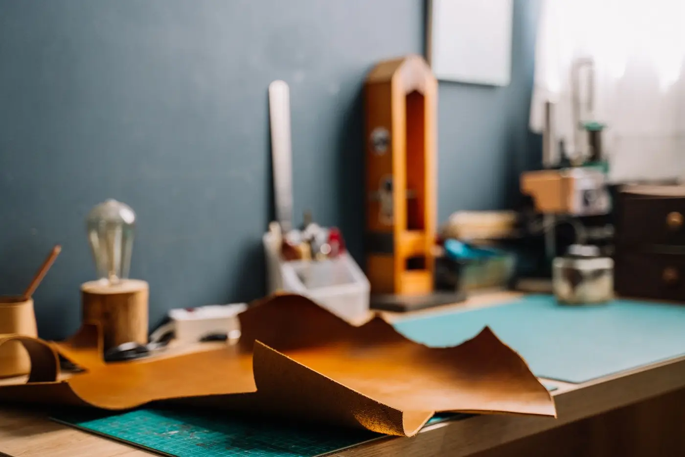 Leather hides and crafting tools laid out on a workshop bench