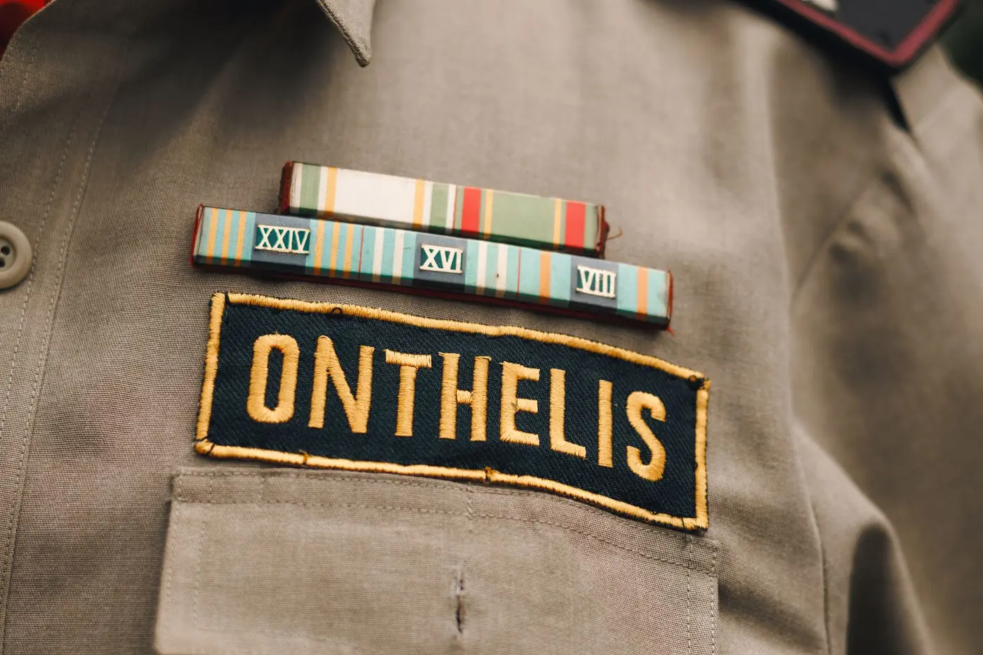 A uniform shirt showing a woven name tape and ribbon bar