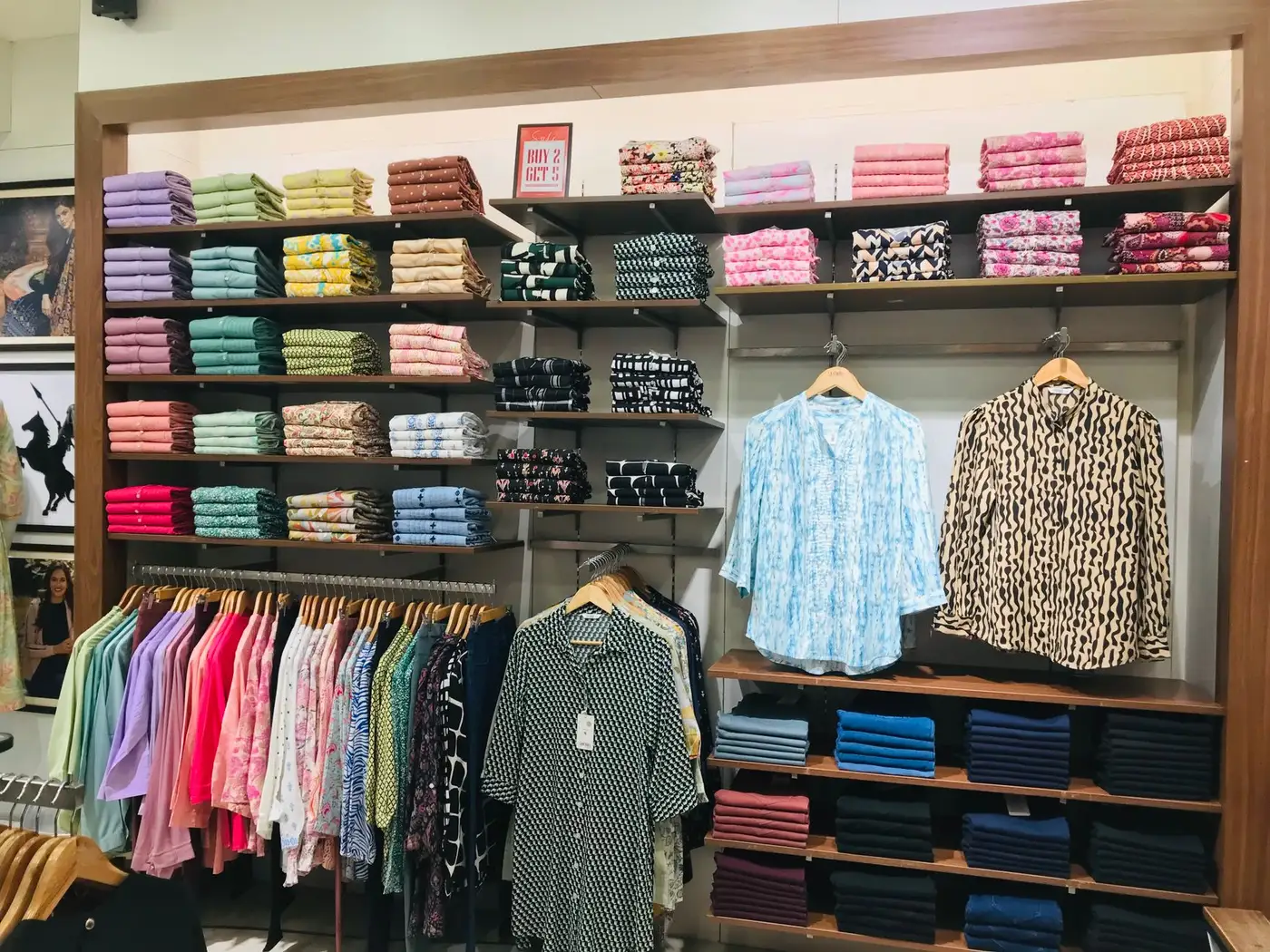 A retail display with racks and shelves of apparel