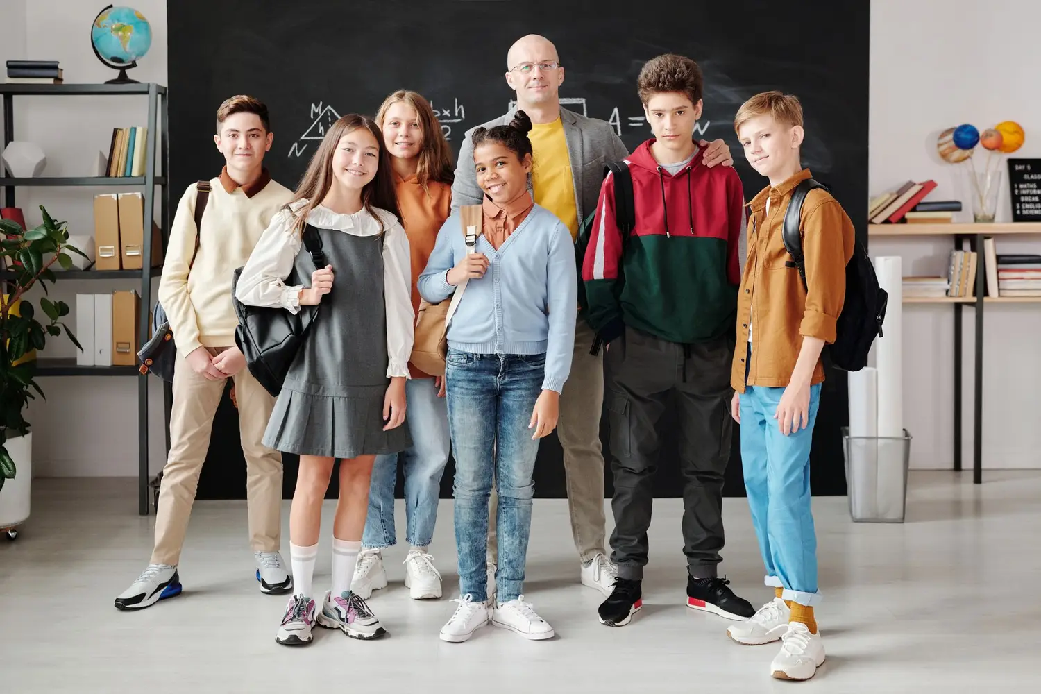 A teacher and students together at school in coordinated apparel