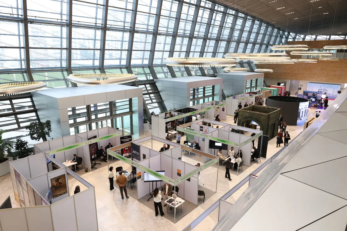 A large trade show exhibition hall filled with booths and attendees