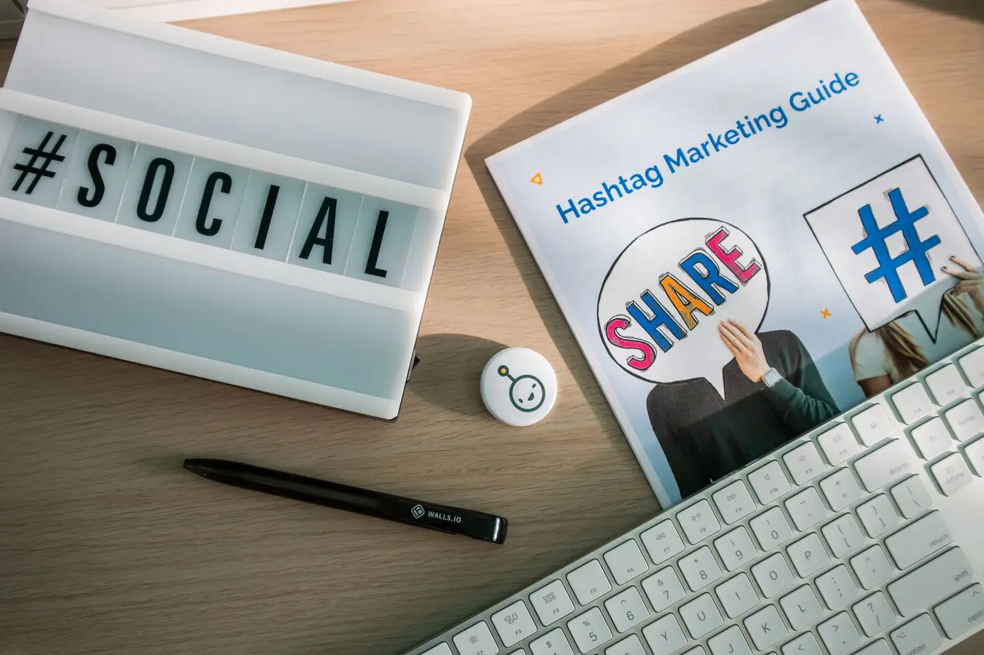 A desk setup with marketing materials and a keyboard