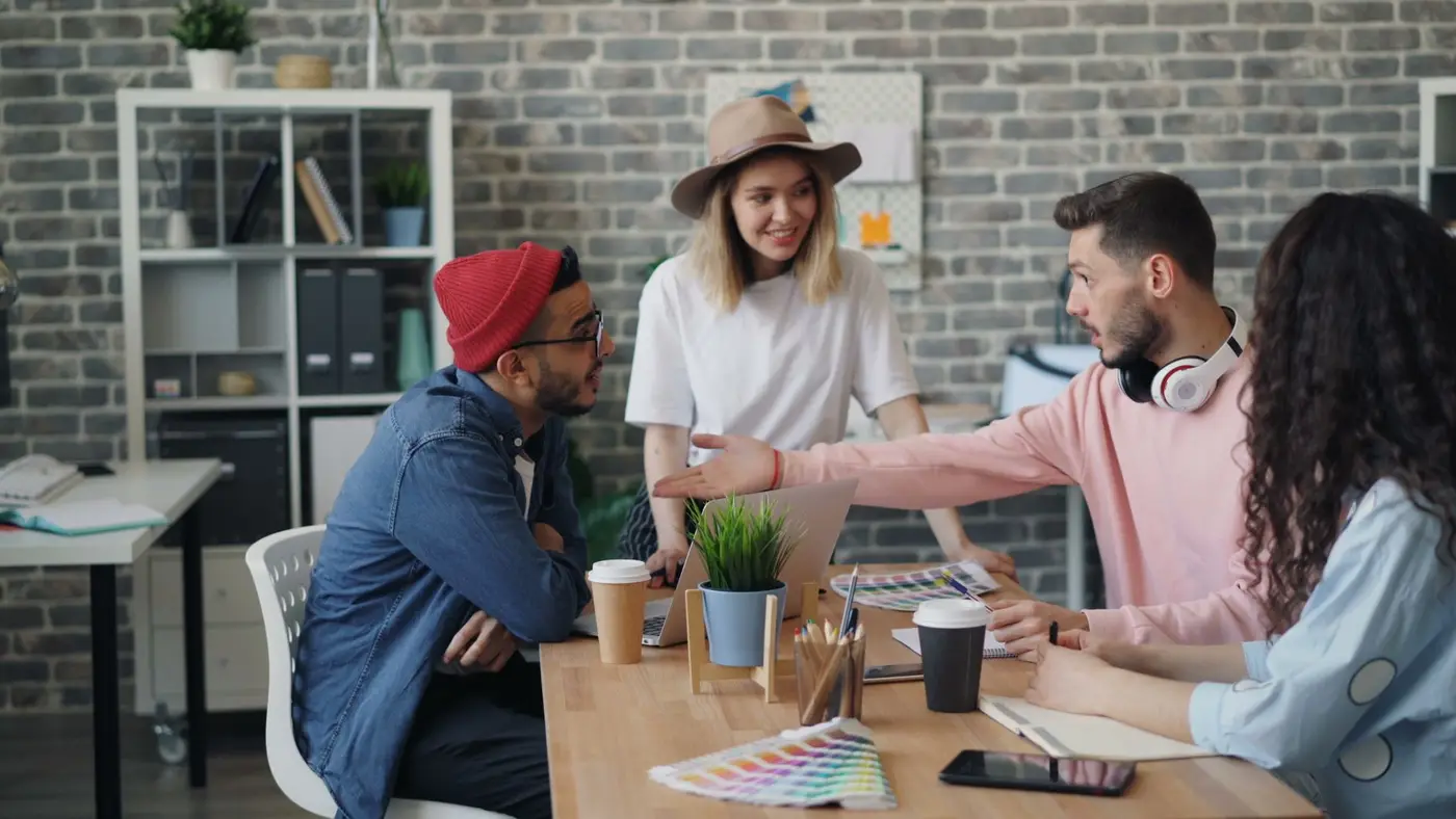 Young professionals collaborating around a laptop