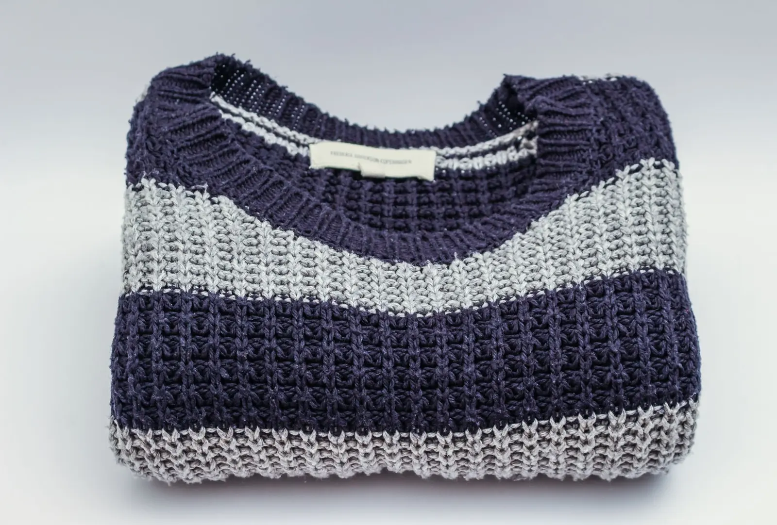 A cozy folded knit sweater, the kind of gift employees actually keep