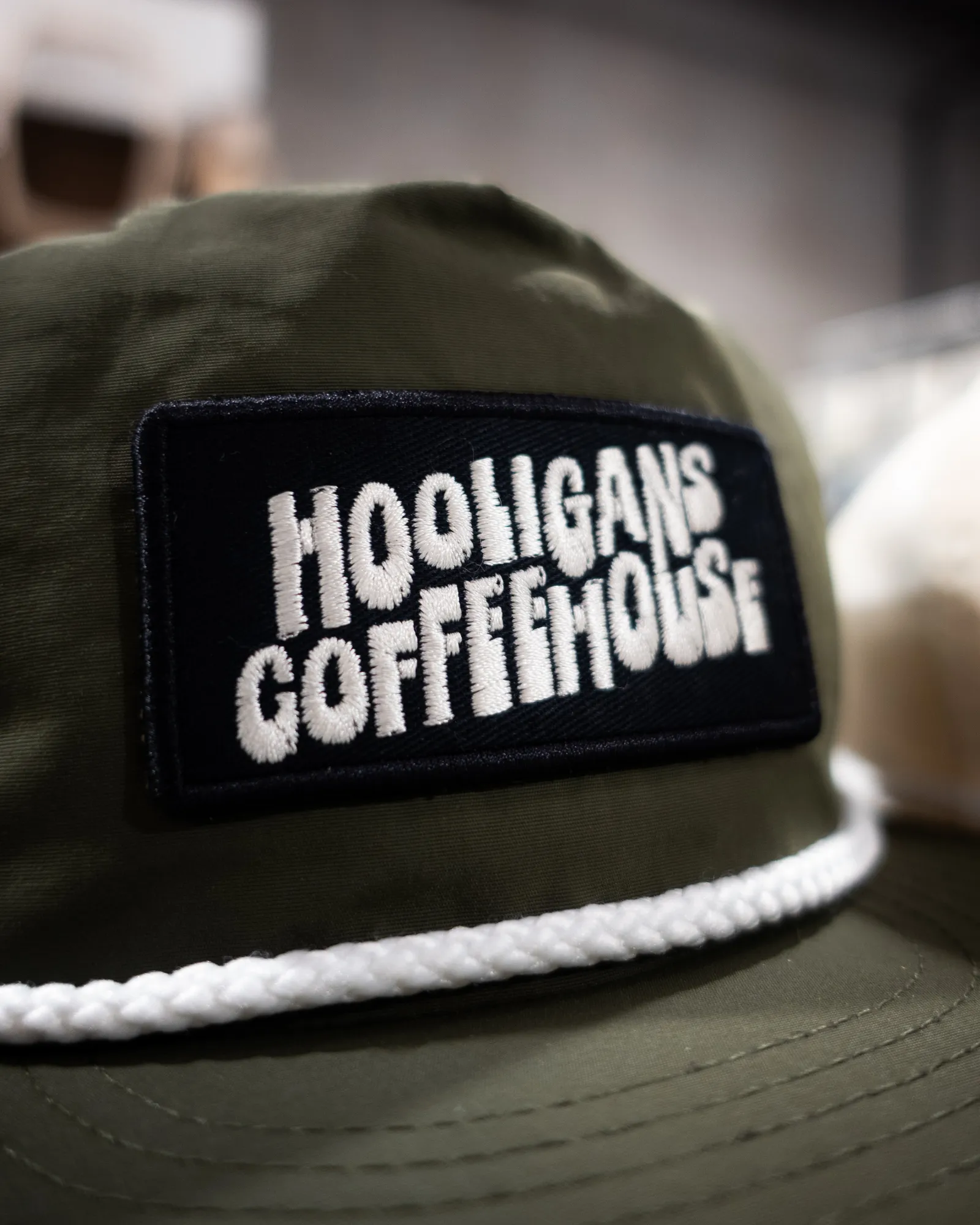 An embroidered patch showing satin-stitch lettering and fill-stitch areas