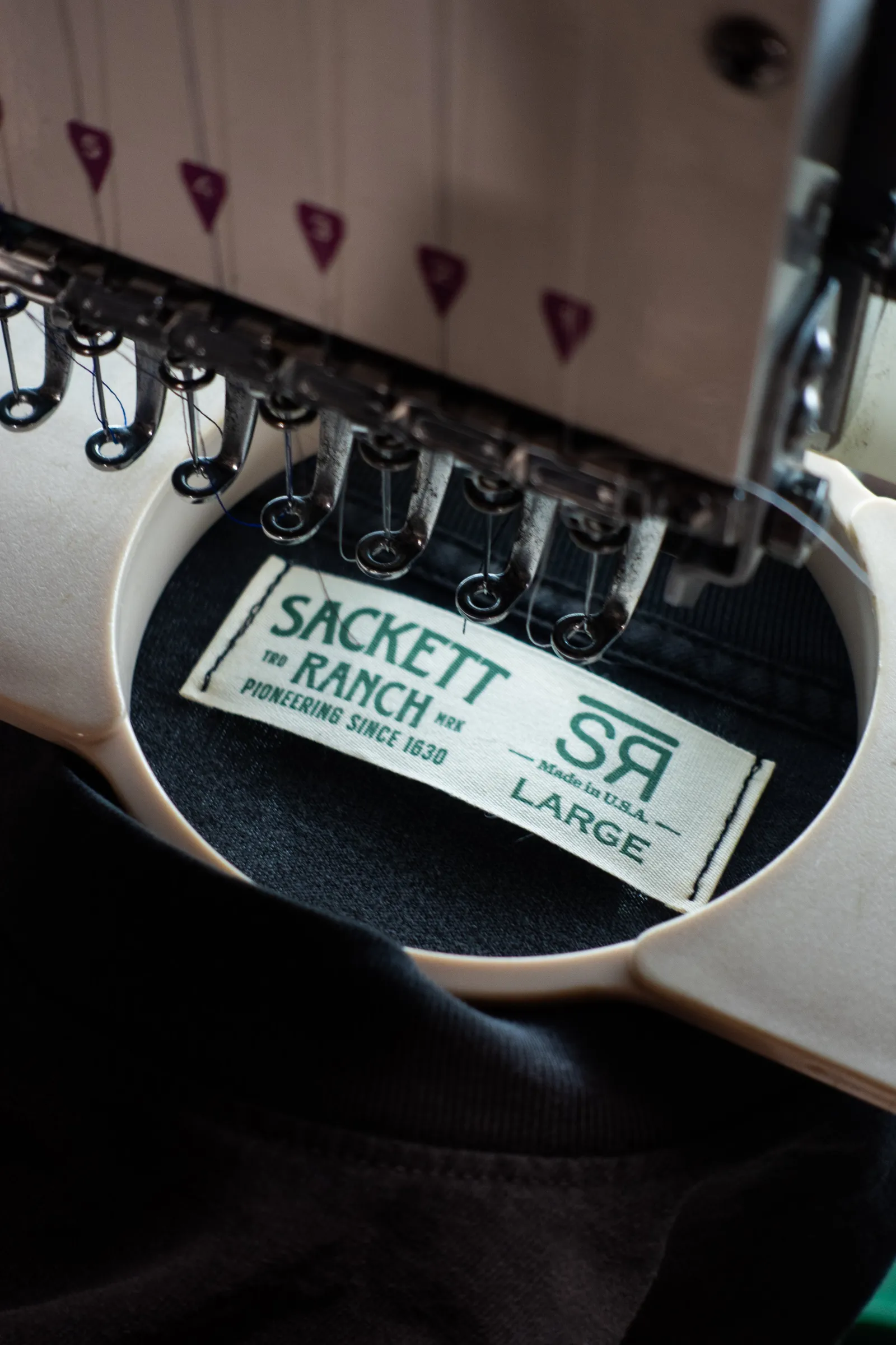 A garment hooped and ready for embroidery in the shop